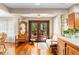 Open-concept living area with French doors leading to the outdoors, hardwood floors, and seating at 1056 Reynolds Rd, De Leon Springs, FL 32130