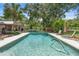 Refreshing pool surrounded by tropical landscaping and a spacious deck for lounging and relaxation in the sun at 1056 Reynolds Rd, De Leon Springs, FL 32130
