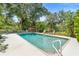 In-ground pool is surrounded by lush landscaping creating a private outdoor oasis at 1056 Reynolds Rd, De Leon Springs, FL 32130