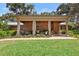 Charming front porch with brick pillars and welcoming seating area at 1056 Reynolds Rd, De Leon Springs, FL 32130