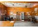 Rustic tasting room featuring wood walls, lighting fixtures, and a vintage display cabinet at 1056 Reynolds Rd, De Leon Springs, FL 32130