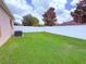 Fenced backyard with lush green grass and mature trees at 110 No Name Key Dr, Deland, FL 32720