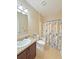 Bathroom with a vanity, toilet, and shower-tub combo with a nautical curtain that provides relaxation and functionality at 110 No Name Key Dr, Deland, FL 32720