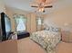 Cozy bedroom featuring floral bedding, natural light, and ample space, perfect for relaxation and restful nights at 110 No Name Key Dr, Deland, FL 32720
