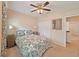 Comfortable bedroom with a double bed, ceiling fan, carpet floors, and natural light that provide comfort and relaxation at 110 No Name Key Dr, Deland, FL 32720