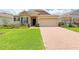 Charming single-Gathering home with manicured lawn and brick-paved driveway at 110 No Name Key Dr, Deland, FL 32720