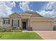 Beautiful single Gathering home with a stone facade, two car garage, and well-manicured lawn at 110 No Name Key Dr, Deland, FL 32720