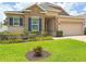 Charming single-story home with stone accents, dark shutters, and a lush green lawn at 110 No Name Key Dr, Deland, FL 32720