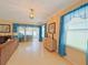 Bright living room with tile floors, natural light, and blue sheer curtains creates a warm, welcoming space at 110 No Name Key Dr, Deland, FL 32720