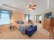 Spacious bedroom with tray ceilings, a ceiling fan, and ensuite bath creates a luxurious retreat for relaxation at 110 No Name Key Dr, Deland, FL 32720