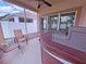 Screened-in porch featuring a hot tub and seating area at 110 No Name Key Dr, Deland, FL 32720