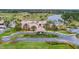 Expansive aerial view of the clubhouse, pool, and golf course, showcasing the community's luxurious amenities at 112 Lost Ball Dr, Daytona Beach, FL 32124