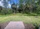 Enjoy the serene backyard with a brick patio and lush greenery, perfect for relaxation at 112 Lost Ball Dr, Daytona Beach, FL 32124