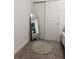 Cozy bedroom with a decorative rug, a large mirror, and closet doors at 112 Lost Ball Dr, Daytona Beach, FL 32124