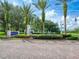 Attractive entrance to Restaurant & Golf with palm trees and manicured landscaping, creating a welcoming ambiance at 112 Lost Ball Dr, Daytona Beach, FL 32124