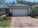 Charming one-story home features a paved driveway, neutral colors and a two-car garage at 112 Lost Ball Dr, Daytona Beach, FL 32124