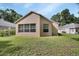 Exterior view shows backyard with a well-maintained lawn and mature landscaping at 1125 Stillwater Dr, Deland, FL 32720
