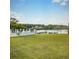 Expansive backyard featuring a lake view with a well-maintained lawn and a fence in a desirable community at 1125 Stillwater Dr, Deland, FL 32720