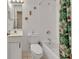 Bright bathroom features a shower over the bath, white tile, and vanity with good lighting at 1125 Stillwater Dr, Deland, FL 32720
