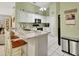 Well-equipped kitchen featuring white cabinetry, stone countertops, and modern appliances at 1125 Stillwater Dr, Deland, FL 32720