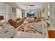 Bright living room features a ceiling fan, window, tile floor, and matching furniture at 1125 Stillwater Dr, Deland, FL 32720