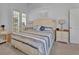 Light and airy main bedroom with french doors, soft colors, and comfortable decor at 1125 Stillwater Dr, Deland, FL 32720