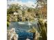 Community pond showcasing fountains and well-maintained landscaping with a small shack in the background at 1125 Stillwater Dr, Deland, FL 32720