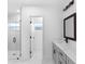 Modern bathroom features a glass shower and dual sinks with gray cabinetry at 1163 W Hancock Dr, Deltona, FL 32725