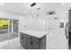 The open kitchen flows into the living space, featuring a marble countertop island, stainless steel appliances, and modern finishes at 1163 W Hancock Dr, Deltona, FL 32725