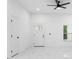 Bright living room features a modern ceiling fan, white walls, and tiled floors at 1163 W Hancock Dr, Deltona, FL 32725