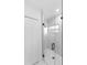 Modern shower with glass door and white tiled walls and floor at 1163 W Hancock Dr, Deltona, FL 32725