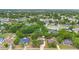 The aerial view captures the neighborhood's lush greenery and residential homes at 1204 Lawrence Ave, Deltona, FL 32725