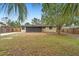 The property's backyard features a screened-in porch and partial fencing for privacy and outdoor enjoyment at 1204 Lawrence Ave, Deltona, FL 32725
