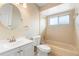 Bathroom with a vanity, toilet, mirror, and shower-tub combination at 1204 Lawrence Ave, Deltona, FL 32725