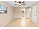 Bedroom with tile floors, ceiling fan, window and view to bathroom, and closet at 1204 Lawrence Ave, Deltona, FL 32725