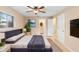Comfortable bedroom featuring a ceiling fan and an attached bathroom at 1204 Lawrence Ave, Deltona, FL 32725