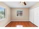 Bedroom featuring wood-look floors, a ceiling fan, two windows, and a closet at 1204 Lawrence Ave, Deltona, FL 32725
