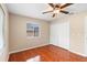 Bedroom featuring wood-look floors, a ceiling fan, a window, and a closet at 1204 Lawrence Ave, Deltona, FL 32725