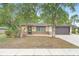 Inviting single-story home with a well-maintained yard and mature trees at 1204 Lawrence Ave, Deltona, FL 32725
