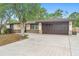 Charming single-story home with a well-maintained lawn, attached garage, and mature shade trees at 1204 Lawrence Ave, Deltona, FL 32725