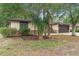 Well-maintained home with brick accents and lush landscaping, enhancing the property's appeal at 1204 Lawrence Ave, Deltona, FL 32725