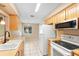 Bright kitchen features tile floors, wooden cabinets, modern appliances, and a butcher block countertop at 1204 Lawrence Ave, Deltona, FL 32725