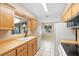 Well-lit kitchen with butcher block countertops, tile flooring, and white appliances at 1204 Lawrence Ave, Deltona, FL 32725