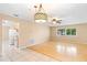 Open concept living space with hardwood and tile floors, ceiling fan and neutral walls at 1204 Lawrence Ave, Deltona, FL 32725