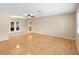 Light filled living room boasts hardwood floors, neutral walls, ceiling fan and windows at 1204 Lawrence Ave, Deltona, FL 32725