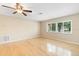Well lit living room featuring hardwood floors, a ceiling fan, and a large window at 1204 Lawrence Ave, Deltona, FL 32725