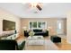 Cozy living room with modern furniture, large windows, and hardwood floors at 1204 Lawrence Ave, Deltona, FL 32725