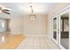 Living room with tile flooring, decorative lighting and glass paneled doors at 1204 Lawrence Ave, Deltona, FL 32725
