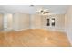 Spacious living room boasts hardwood floors, neutral walls, ceiling fan and glass paneled french doors at 1204 Lawrence Ave, Deltona, FL 32725