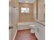 Bathroom with tiled tub, shower, granite vanity, and tile floors at 1226 North St, Daytona Beach, FL 32114